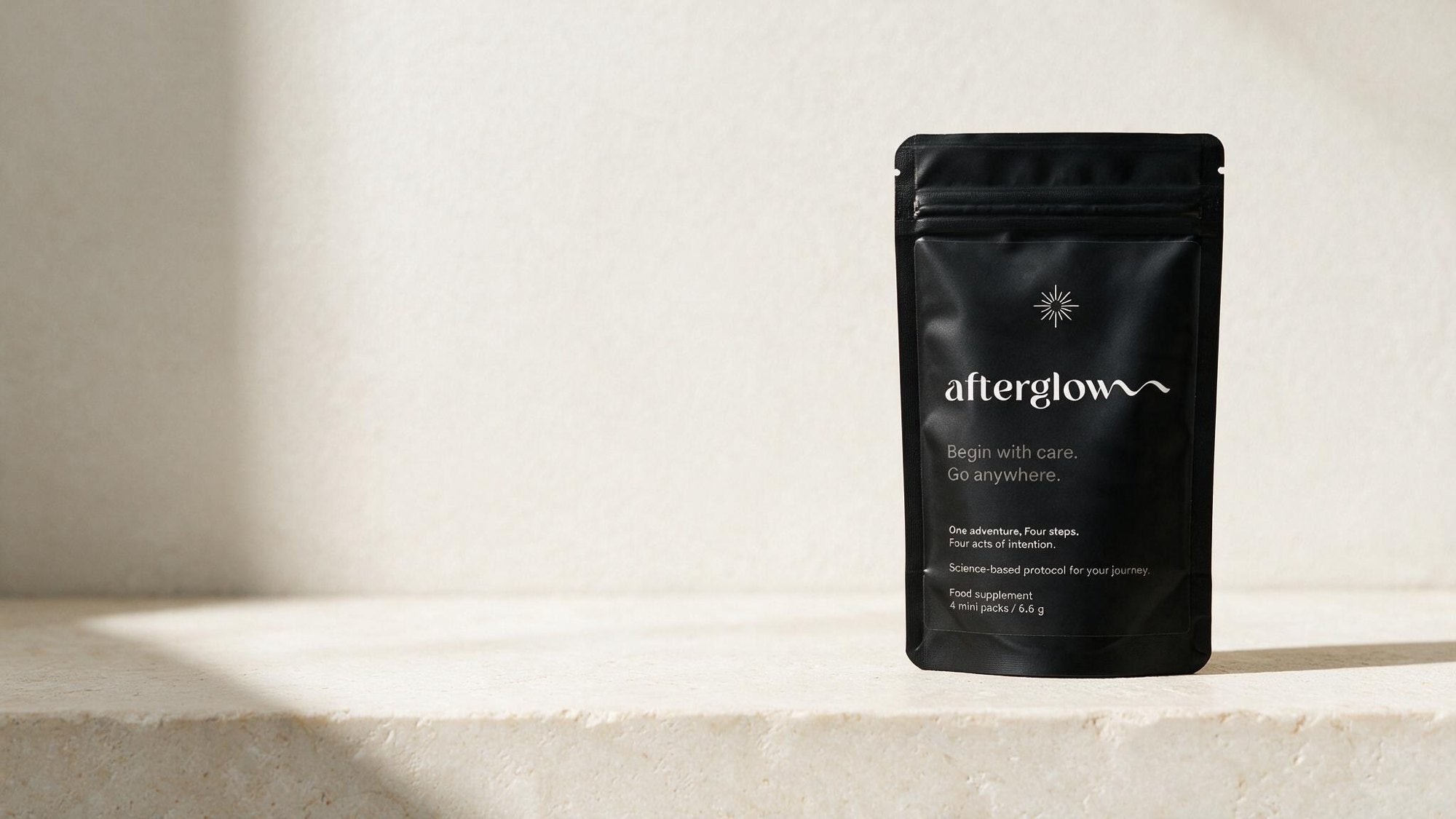 Afterglow Protocol pack standing on a sunlit stone ledge